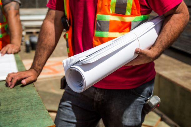 Person holding construction papers